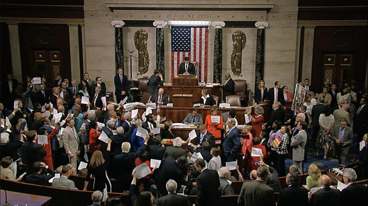 In this image from video provided by House Television, House Speaker Paul Ryan stands at the podium Wednesday while Democrats protest to demand votes on gun control.