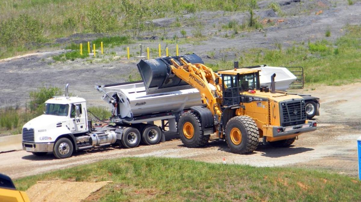 A truck is filled with excavated coal ash at the retired Riverbend power plant near Charlotte.