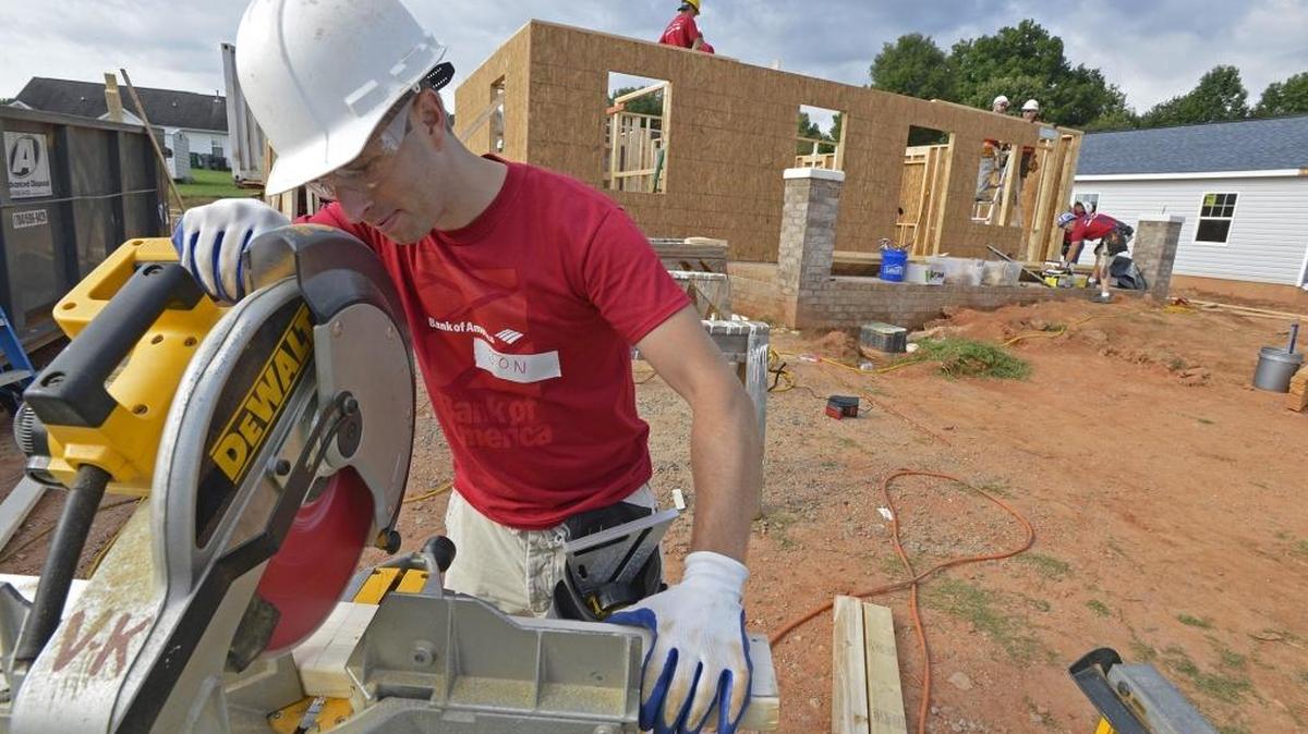 A volunteer helps a Habitat for Humanity building project. Three Charlotte-area chapters of the nonprofit are getting a combined $18.5 million from billionare philanthropist MacKenzie Scott.