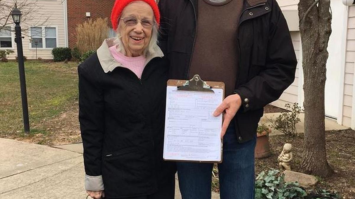 Reba Howser and her son, Ed, with the voter registration form she filled out last week in Asheville.