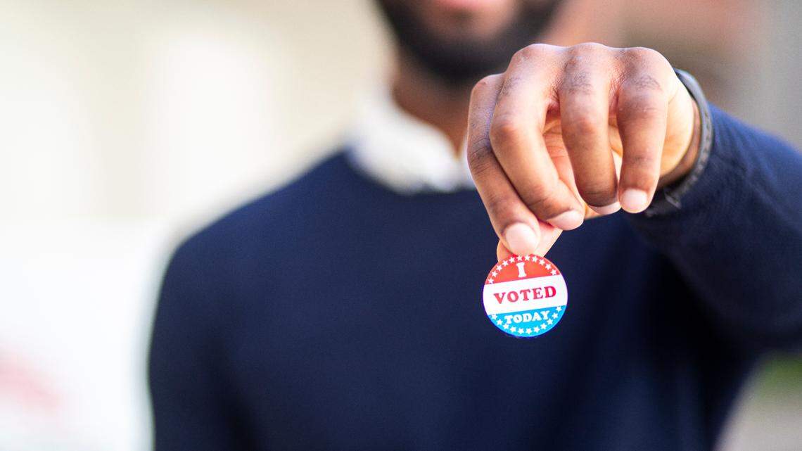 Election Day for the North Carolina primaries is March 5. A man holds an "I voted" election sticker in a share image for election endorsements