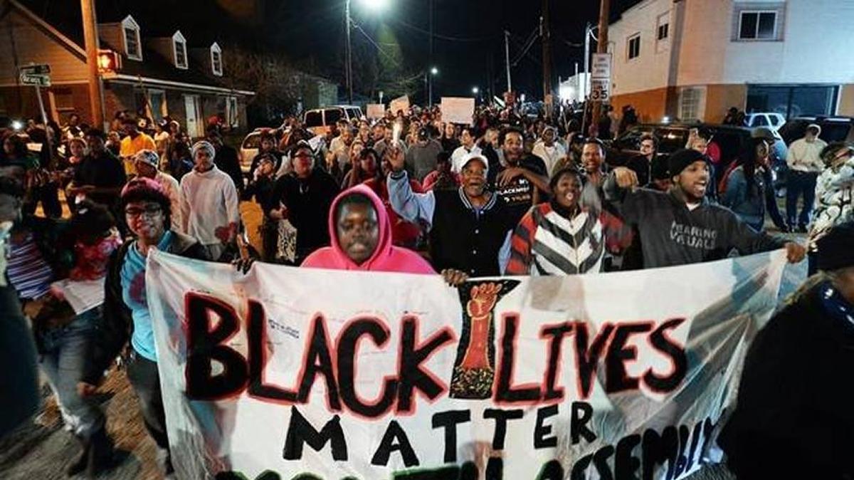 A crowd marches in Raleigh after speakers memorialized Akiel Denkins, who was killed this week.