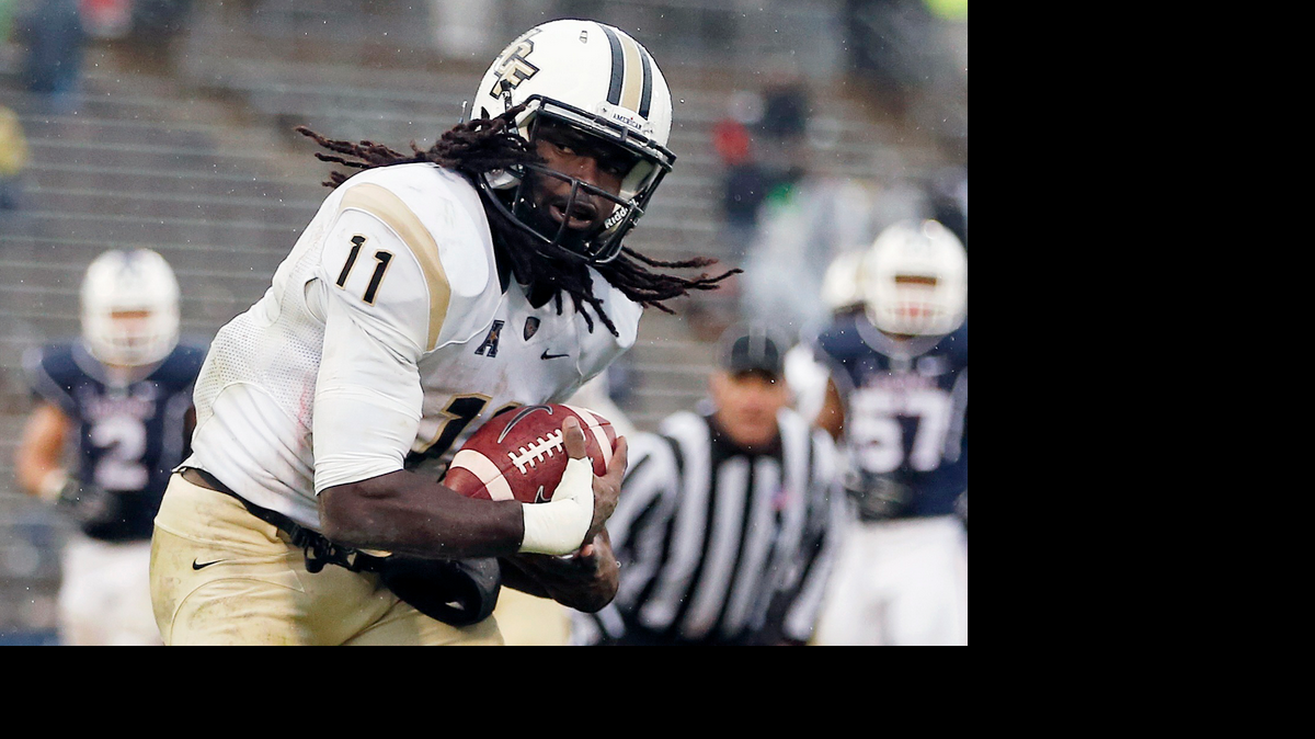 Central Florida wide receiver Breshad Perriman (11) breaks a tackle by Connecticut cornerback Jhavon Williams (6) after Perriman's touchdown reception in the fourth quarter of an NCAA college football game in East Hartford, Conn., Saturday, Nov. 1, 2014. Connecticut won 37-29. (AP Photo/Michael Dwyer)