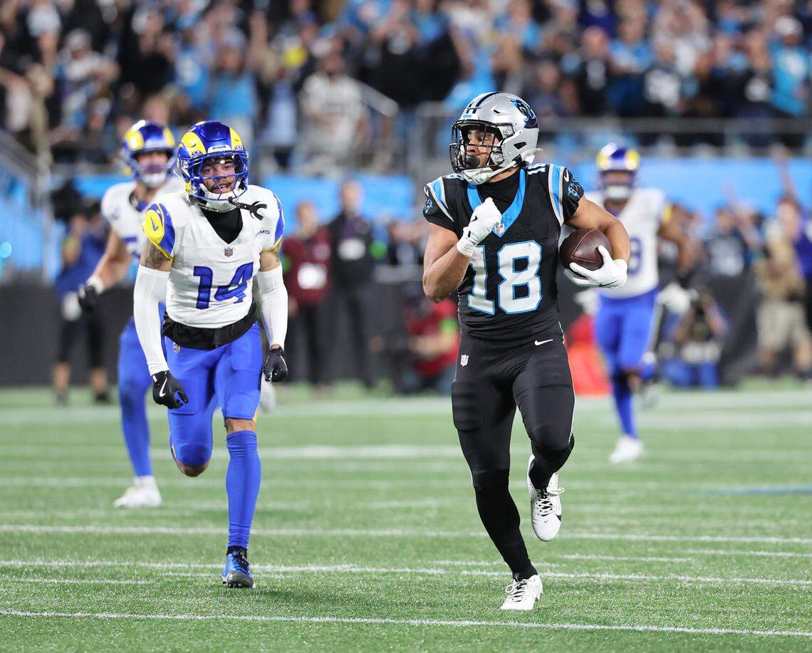 Carolina Panthers Jalen Coker rushes for yardage against Los Angeles Rams Cobie Durant during the wild card playoff game at Bank of America Stadium on Saturday, Jan. 10, 2025 in Charlotte