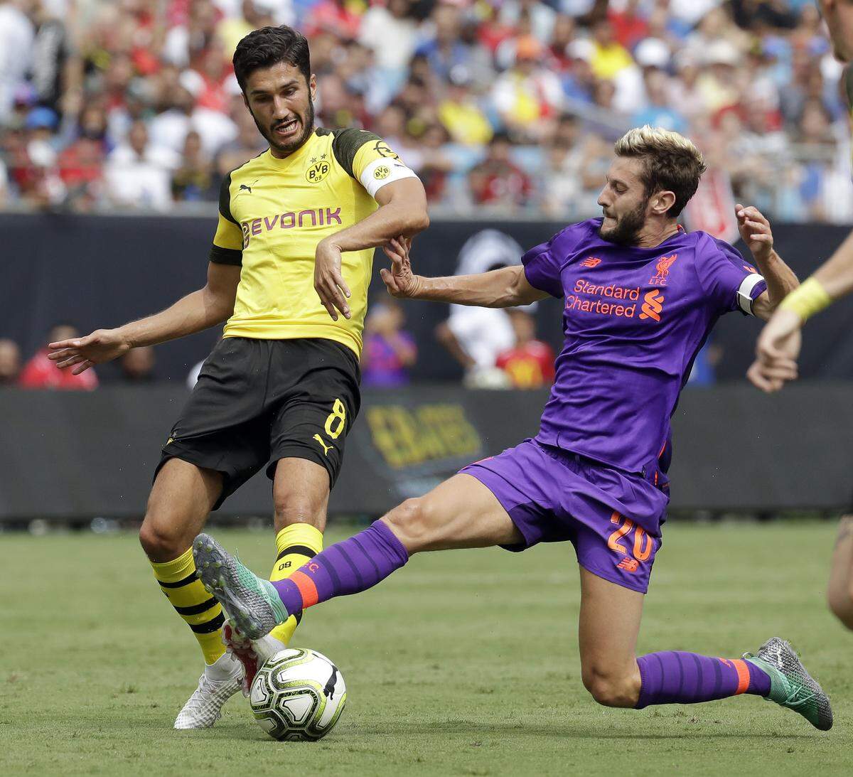 Borussia Dortmund's Nuri Sahin (8) battles Liverpool's Adam Lallana (20) during an International Champions Cup tournament soccer match in Charlotte, N.C., Sunday, July 22, 2018. (AP Photo/Chuck Burton)
