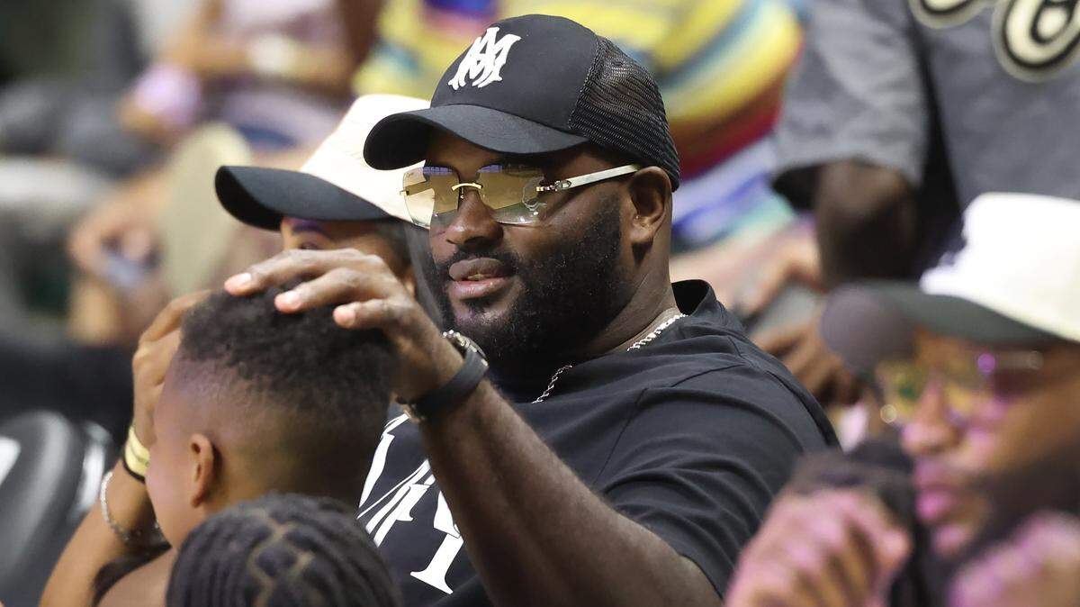 Carolina Panthers offensive tackle Taylor Moton sits courtside at the Chewy Takeover Celebrity Basketball Game at UNC Charlotte on Sunday, April 12, 2026. The game brings together professional athletes, entertainers and regional influencers for a high-energy community event.