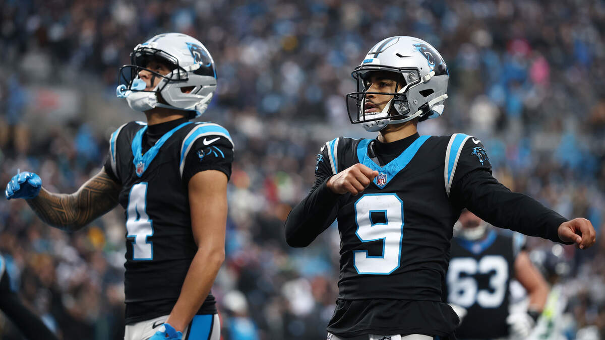 Bryce Young celebrates a touchdown with Carolina Panthers teammate Tetairoa McMillan during the game in Charlotte on Sunday, Dec. 28, 2025.