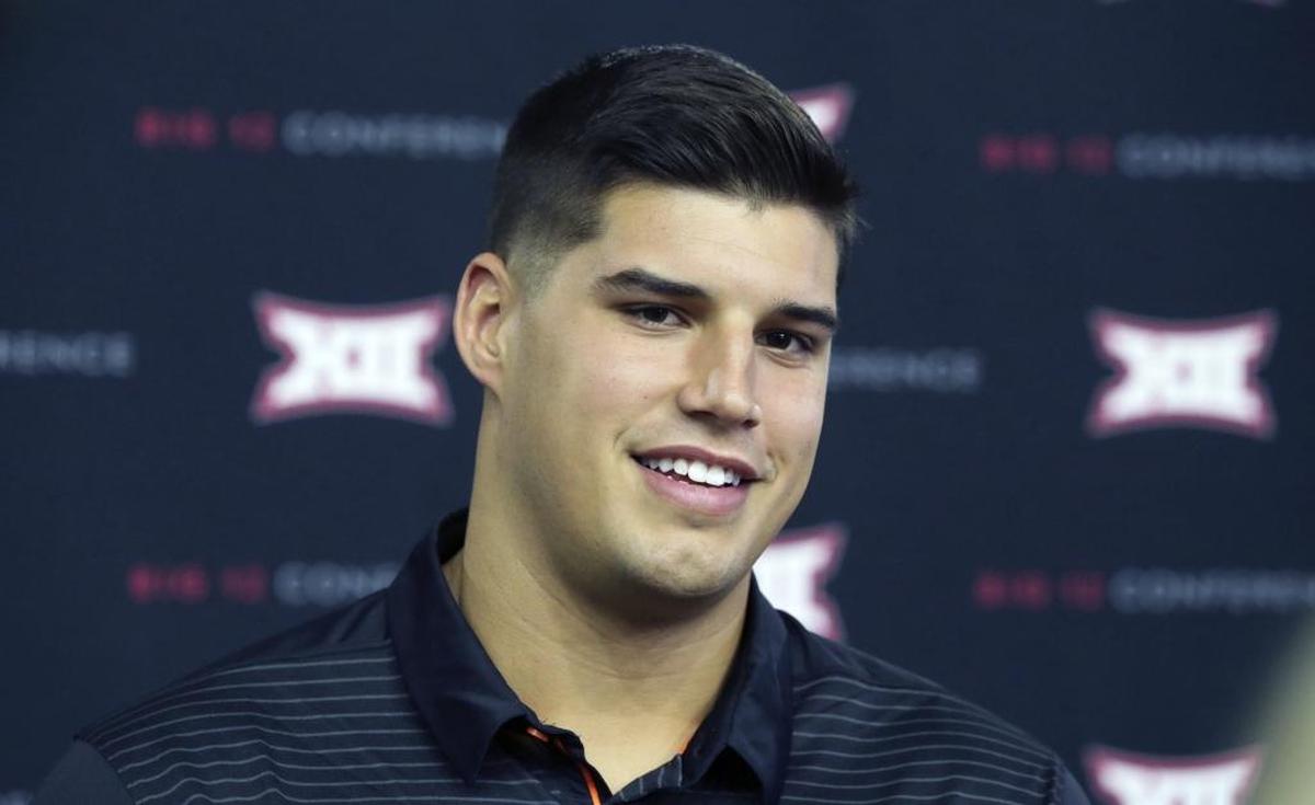 FILE - In this July 18, 2017, file photo, Oklahoma State quarterback Mason Rudolph smiles while giving an interview during the Big 12 NCAA college football media day in Frisco, Texas. Oklahoma State believes quarterback Mason Rudolph has a shot at the Heisman Trophy. He made an early impression in the tenth-ranked Cowboys win over Tulsa on Thursday night, Aug. 31. (AP Photo/LM Otero)