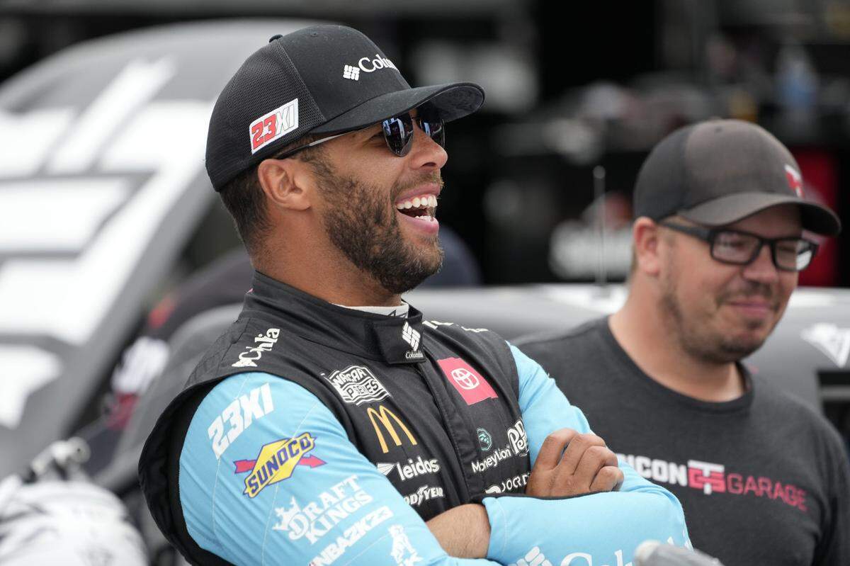 May 19, 2023; North Wilkesboro, North Carolina, USA; Nascart Craftsman Truck Series driver Bubba Wallace (1) has a laugh during truck practice at North Wilkesboro Speedway. Mandatory Credit: Jim Dedmon-USA TODAY Sports