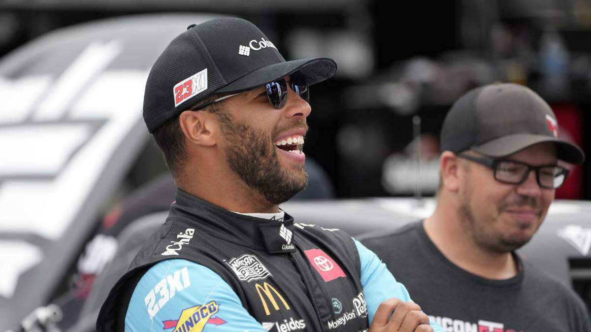 May 19, 2023; North Wilkesboro, North Carolina, USA; Nascart Craftsman Truck Series driver Bubba Wallace (1) has a laugh during truck practice at North Wilkesboro Speedway. Mandatory Credit: Jim Dedmon-USA TODAY Sports