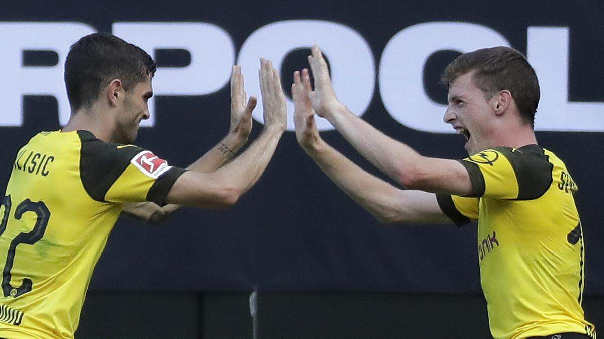 Borussia Dortmund's Christian Pulisic (22) celebrates with Sergio Gomez (17) after scoring a goal against Liverpool during the second half of an International Champions Cup tournament soccer match in Charlotte, N.C., Sunday, July 22, 2018. (AP Photo/Chuck Burton)