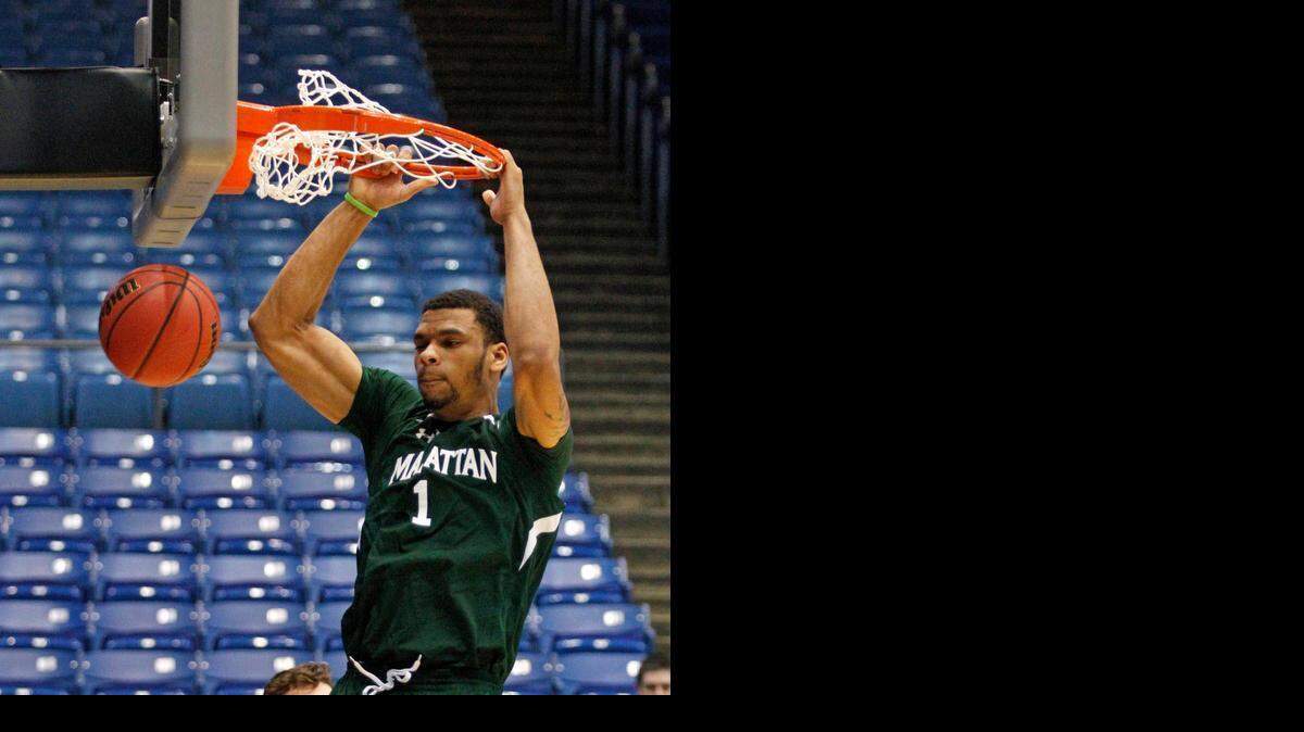 
Ashton Pankey dunks during practice for an NCAA college basketball first round game Monday, March 16, 2015, in Dayton, Ohio. Manhattan plays Hampton in Dayton on Tuesday. 
