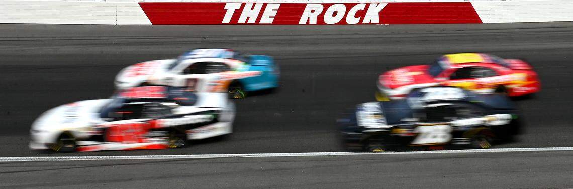 NASCAR Xfinity Series drivers blur past The Rock during action in the North Carolina Education Lottery 250 at Rockingham Speedway on April 19, 2025.