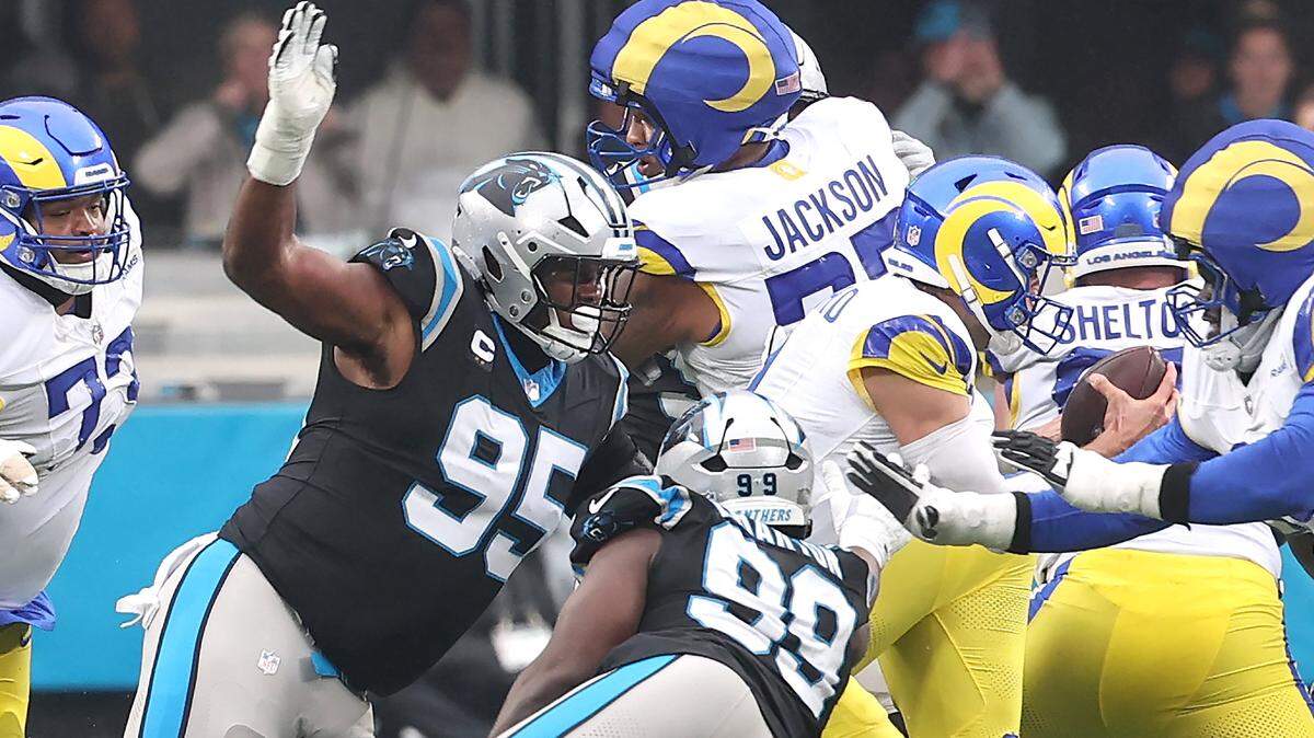 Carolina Panthers defensive tackle Derrick Brown, left, pressures Los Angeles Rams quarterback Matthew Stafford, right, in the pocket at Bank of America Stadium in Charlotte, NC on Sunday, November 30, 2025. Brown would cause Stafford to fumble the ball with the Panthers recovering. The Panthers defeated the Rams 31-28.