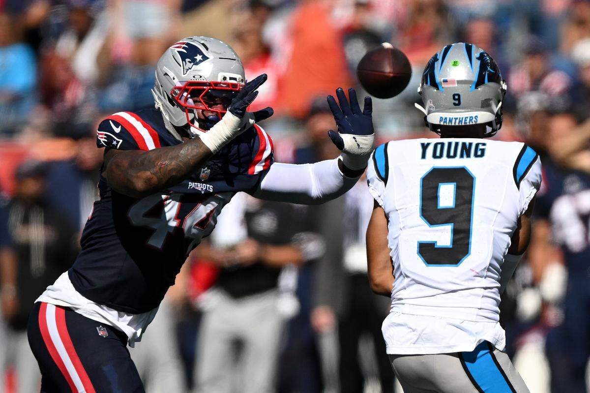 New England Patriots linebacker K'Lavon Chaisson (44) defends Carolina Panthers quarterback Bryce Young (9) during Sunday’s first half at Gillette Stadium in Foxborough