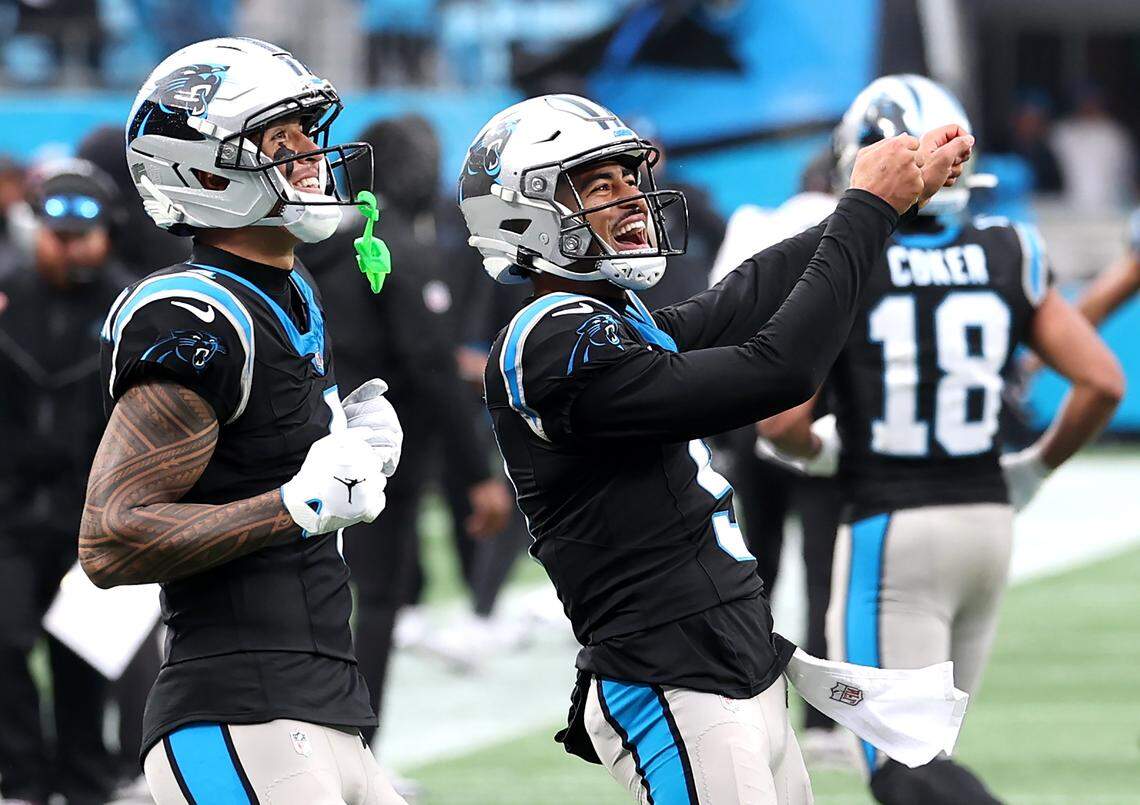 Carolina Panthers wide receiver Tetairoa McMillan, left and quarterback Bryce Young, right, celebrate their touchdown pass and reception during fourth-quarter action on Nov. 30, 2025, against the Los Angeles Rams at Bank of America Stadium in Charlotte. The Panthers defeated the Rams 31-28.