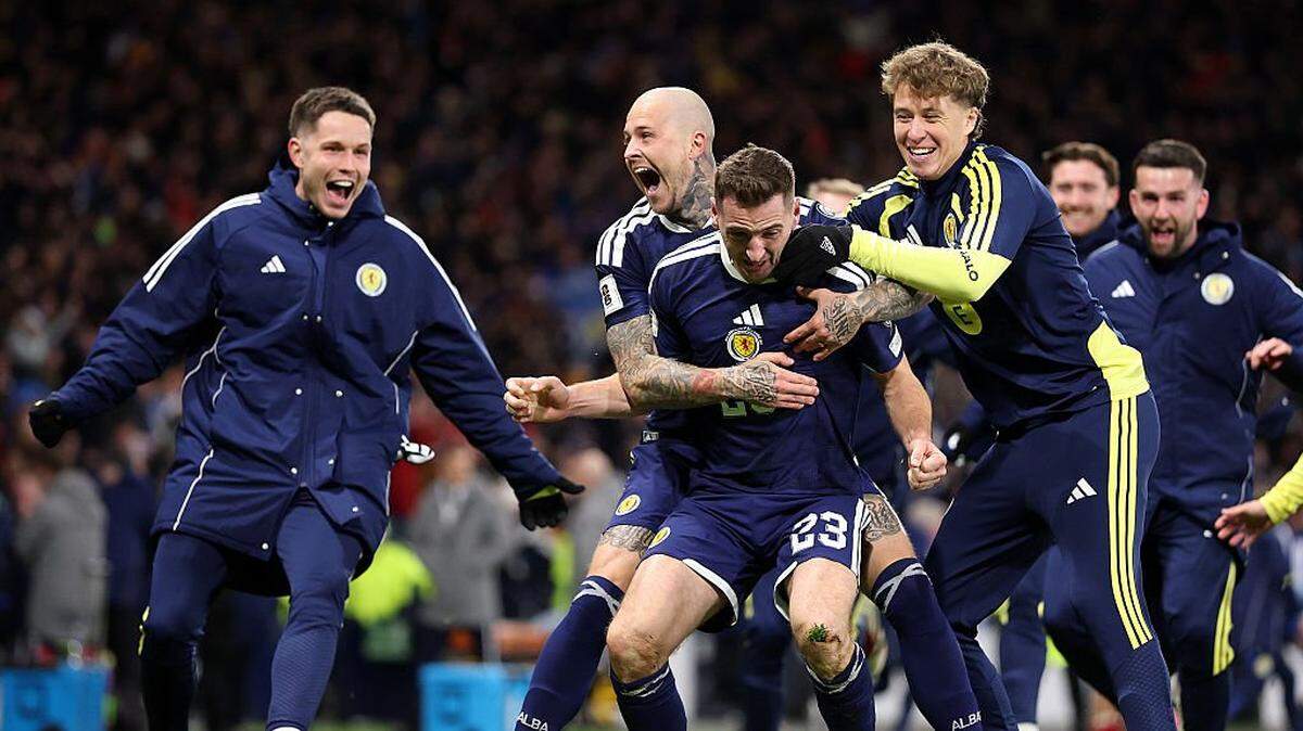 GLASGOW, SCOTLAND - NOVEMBER 18: Scotland player Kenny McLean celebrates with Lyndon Dykes and team mates after scoring the fourth Scotland goal during the FIFA World Cup 2026 qualifier match between Scotland and Denmark at Hampden Park on November 18, 2025 in Glasgow, Scotland. (Photo by Stu Forster/Getty Images)