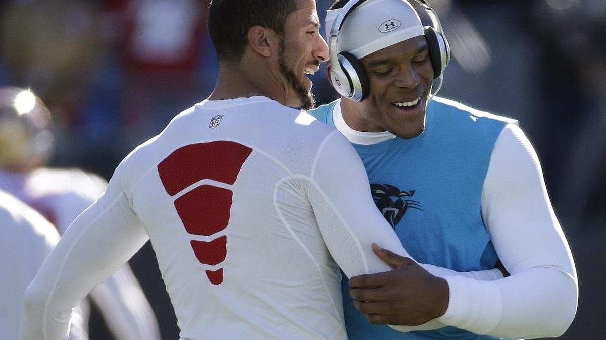 San Francisco 49ers quarterback Colin Kaepernick, left and Carolina Panthers quarterback Cam Newton, seen before a 2014 playoff game, recently cleared the air about a photo from last week’s game that made them appear angry at each other (AP Photo/John Bazemore)