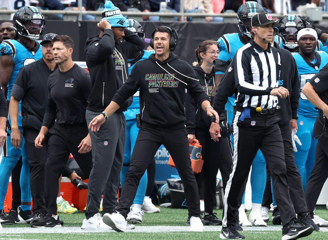 Carolina Panthers head coach Dave Canales, center, questions a call during action against the Dallas Cowboys on Sunday, October 12, 2025 at Bank of America Stadium. The Panthers defeated the Cowboys 30-27.