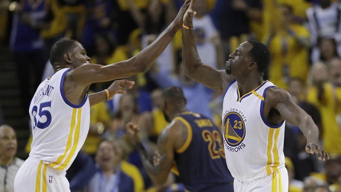 Golden State Warriors forward Kevin Durant (35) and forward Draymond Green (23) celebrate during the second half of Game 1 of basketball's NBA Finals against the Cleveland Cavaliers in Oakland, Calif., Thursday, June 1, 2017. (AP Photo/Marcio Jose Sanchez)