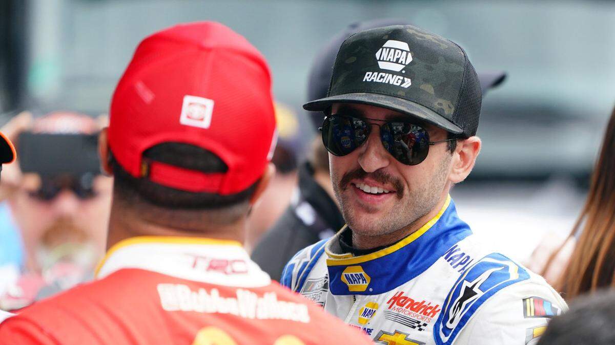 Apr 15, 2023; Martinsville, Virginia, USA; NASCAR Cup Series driver Chase Elliott (9) talks with NASCAR Cup Series driver Bubba Wallace (23) on pit road before practice and qualifying at Martinsville Speedway. Mandatory Credit: John David Mercer-USA TODAY Sports