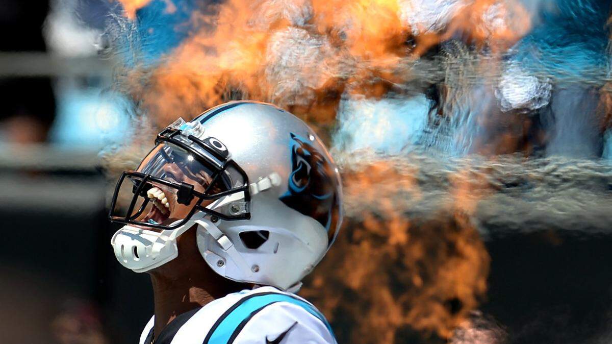 Carolina Panthers quarterback Cam Newton yells as he is introduced during play intros through the shooting flames on Sunday, September 8, 2019 at Bank of America Stadium in Charlotte, N.C.
