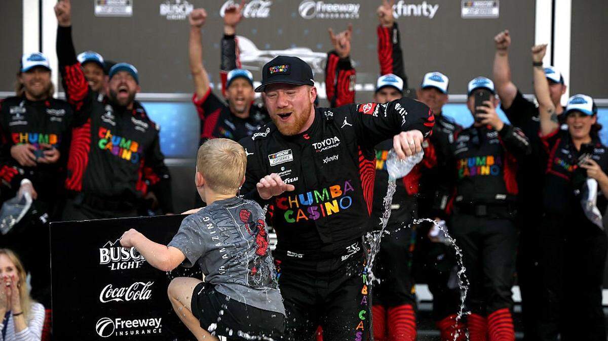 DAYTONA BEACH, FLORIDA - FEBRUARY 15: Tyler Reddick, driver of the #45 Chumba Casino Toyota, and son, Beau Reddick celebrate in victory lane after winning the NASCAR Cup Series Daytona 500 at Daytona International Speedway on February 15, 2026 in Daytona Beach, Florida. (Photo by Chris Graythen/Getty Images)