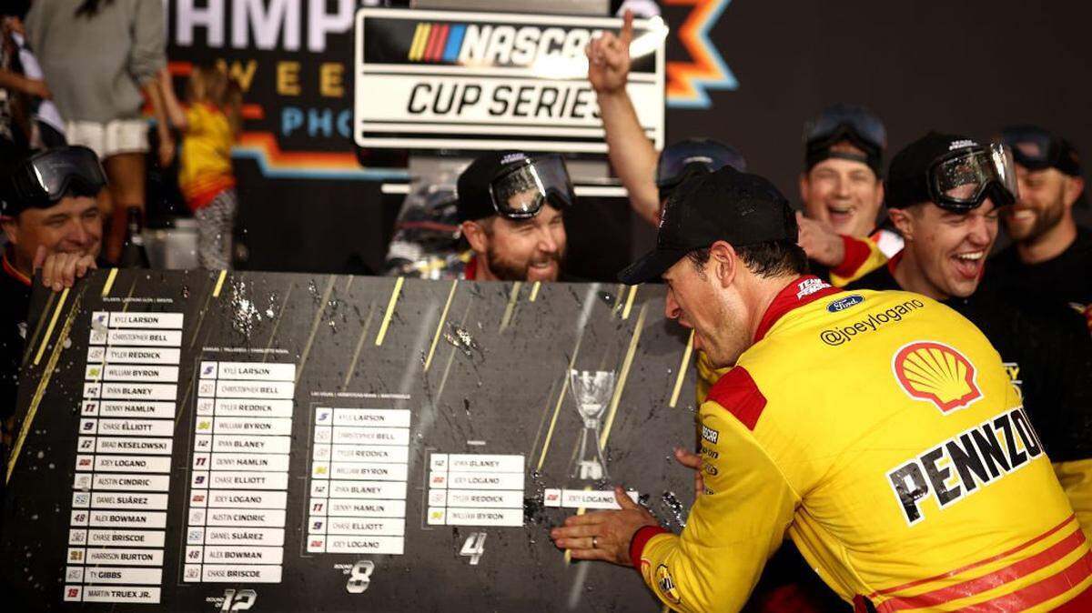AVONDALE, ARIZONA - NOVEMBER 10: Joey Logano, driver of the #22 Shell Pennzoil Ford, places his name in the champion position of the NASCAR Playoffs Grid Challenge in victory lane after winning the NASCAR Cup Series Championship Race at Phoenix Raceway on November 10, 2024 in Avondale, Arizona. (Photo by Jared C. Tilton/Getty Images)