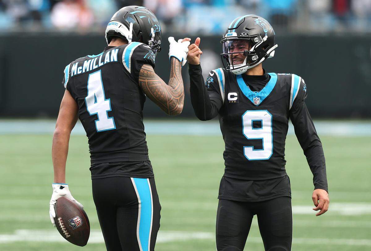 Carolina Panthers wide receiver Tetairoa McMillan, left, is congratulated by quarterback Bryce Young, right, after catching a touchdown pass during action against the Tampa Bay Buccaneers on Sunday, December 21, 2025 at Bank of America Stadium in Charlotte, NC.