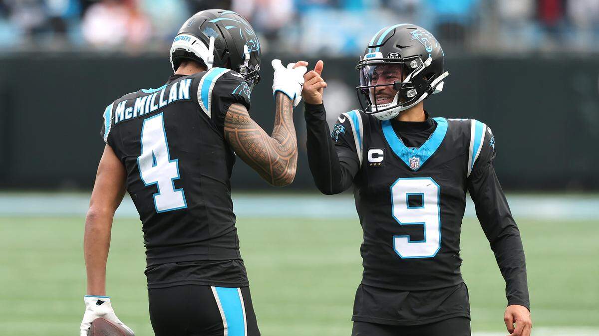Carolina Panthers wide receiver Tetairoa McMillan, left, is congratulated by quarterback Bryce Young, right, after catching a touchdown pass during action against the Tampa Bay Buccaneers on Sunday, December 21, 2025 at Bank of America Stadium in Charlotte, NC.