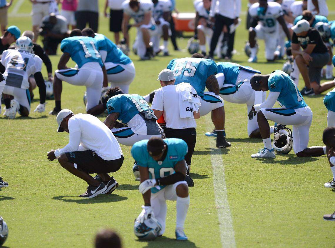 Carolina Panthers players and personnel take a knee while medical personnel tend to tackle Daryl Williams who injured his right leg during practice on Saturday, July 28, 2018. Williams had to be carted from the field. Tackle Taylor Moton replaced Williams. The Panthers are holding training camp at Wofford College in Spartanburg, SC.