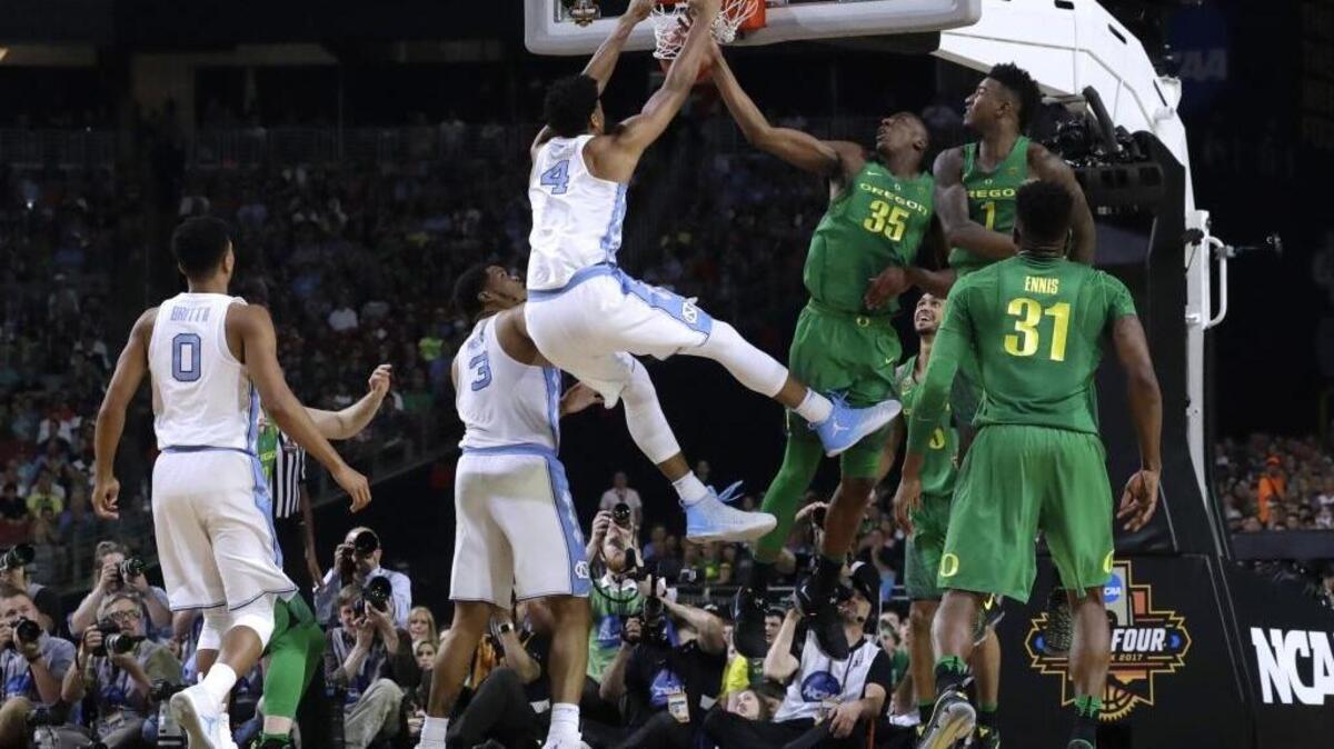 North Carolina forward Isaiah Hicks (4) dunks the ball over Oregon's Kavell Bigby-Williams (35) and Jordan Bell (1) during the first half in the semifinals of the Final Four NCAA college basketball tournament, Saturday, April 1, 2017, in Glendale, Ariz. (AP Photo/David J. Phillip)