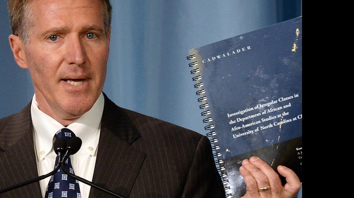 
Kenneth Wainstein, a partner with Cadwalader, Wickersham & Taft LLP, holds up the report on UNC-Chapel Hill's academic problems in association with the athletics department during a press conference at Chapel Hill, Wednesday, Oct. 22, 2014.
