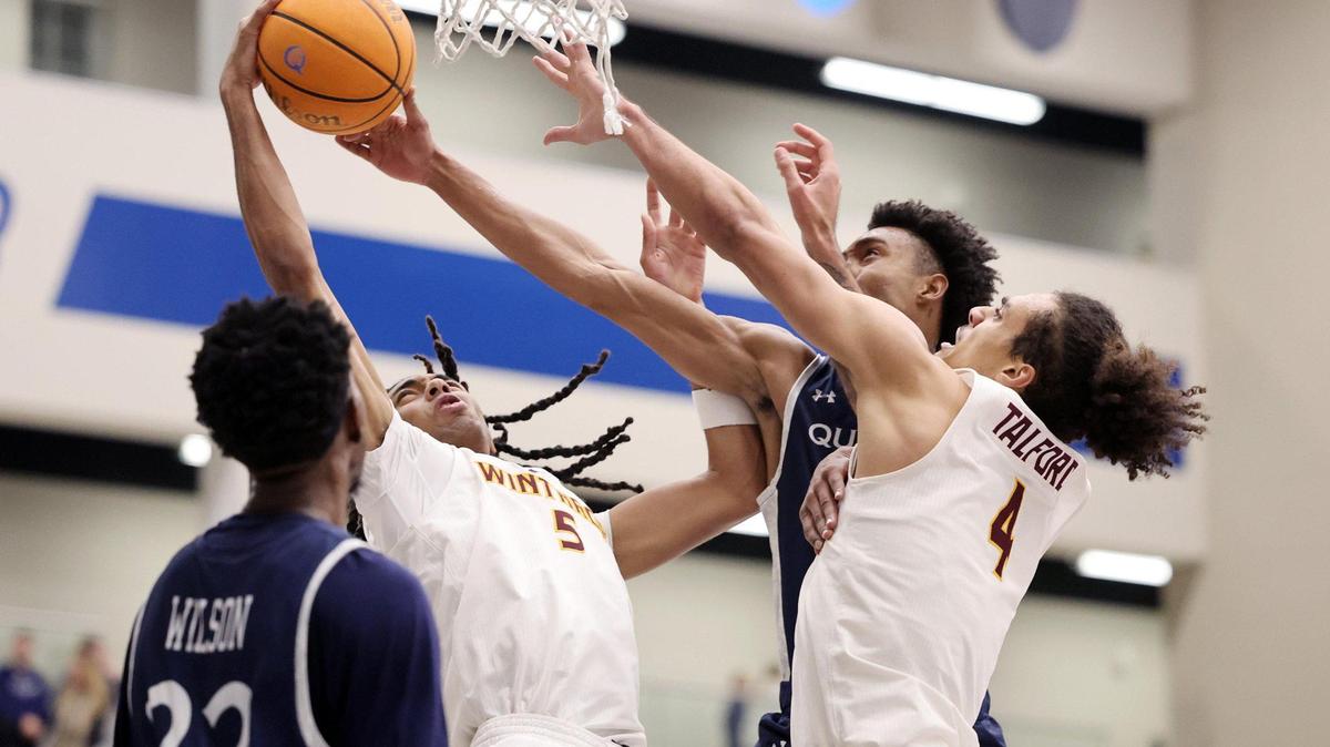 Winthrop’s Yoro Diallo (5) and Kelton Talford (4) try to keep the ball from Queens’ Leo Colimerio Tuesday in Charlotte.