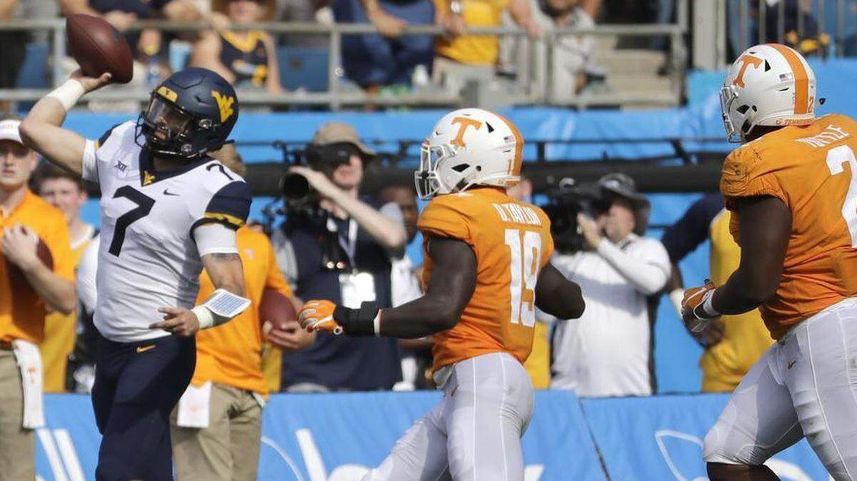 West Virginia quarterback Will Grier completed 25 of 34 passes for 429 yards and five touchdowns in the Mountaineers’ 40-14 victory against Tennessee at Bank of America Stadium on Saturday.
