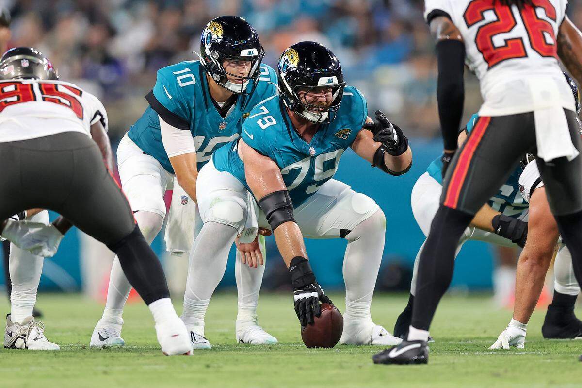 Luke Fortner #79 of the Jacksonville Jaguars calls signals before snapping to Mac Jones #10 against the Tampa Bay Buccaneers during a preseason game Aug. 17, 2024 in Jacksonville, Florida.