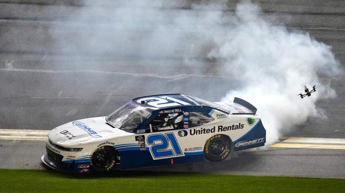 FILE: Austin Hill does a burnout after winning the NASCAR Xfinity Series auto race Saturday, Feb. 19, 2022, at Daytona International Speedway in Daytona Beach, Fla. (AP Photo/Chris O’Meara)
