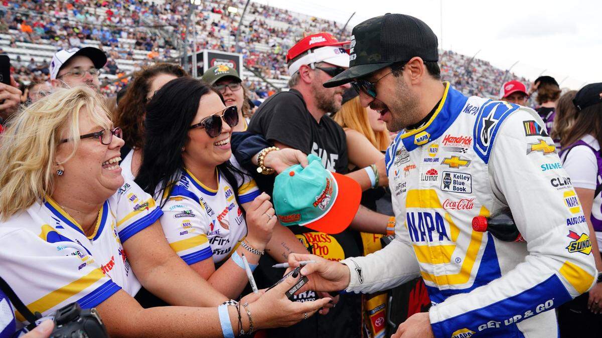 Apr 16, 2023; Martinsville, Virginia, USA; NASCAR Cup Series driver Chase Elliott (9) signs autographs before the NOCO 400 at Martinsville Speedway. Mandatory Credit: John David Mercer-USA TODAY Sports