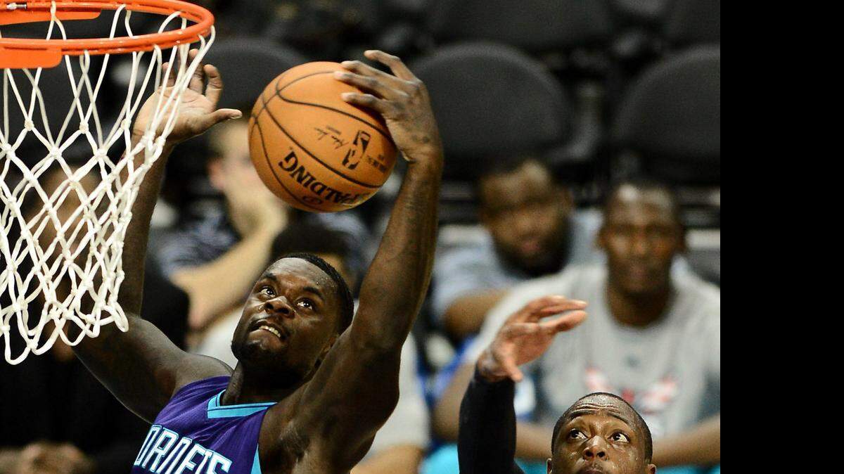 
Charlotte Hornets guard Lance Stephenson (1) pulls down a rebound over Miami Heat guard Dwayne Wade, Nov. 5, 2014 at Time Warner Cable Arena in Charlotte.
