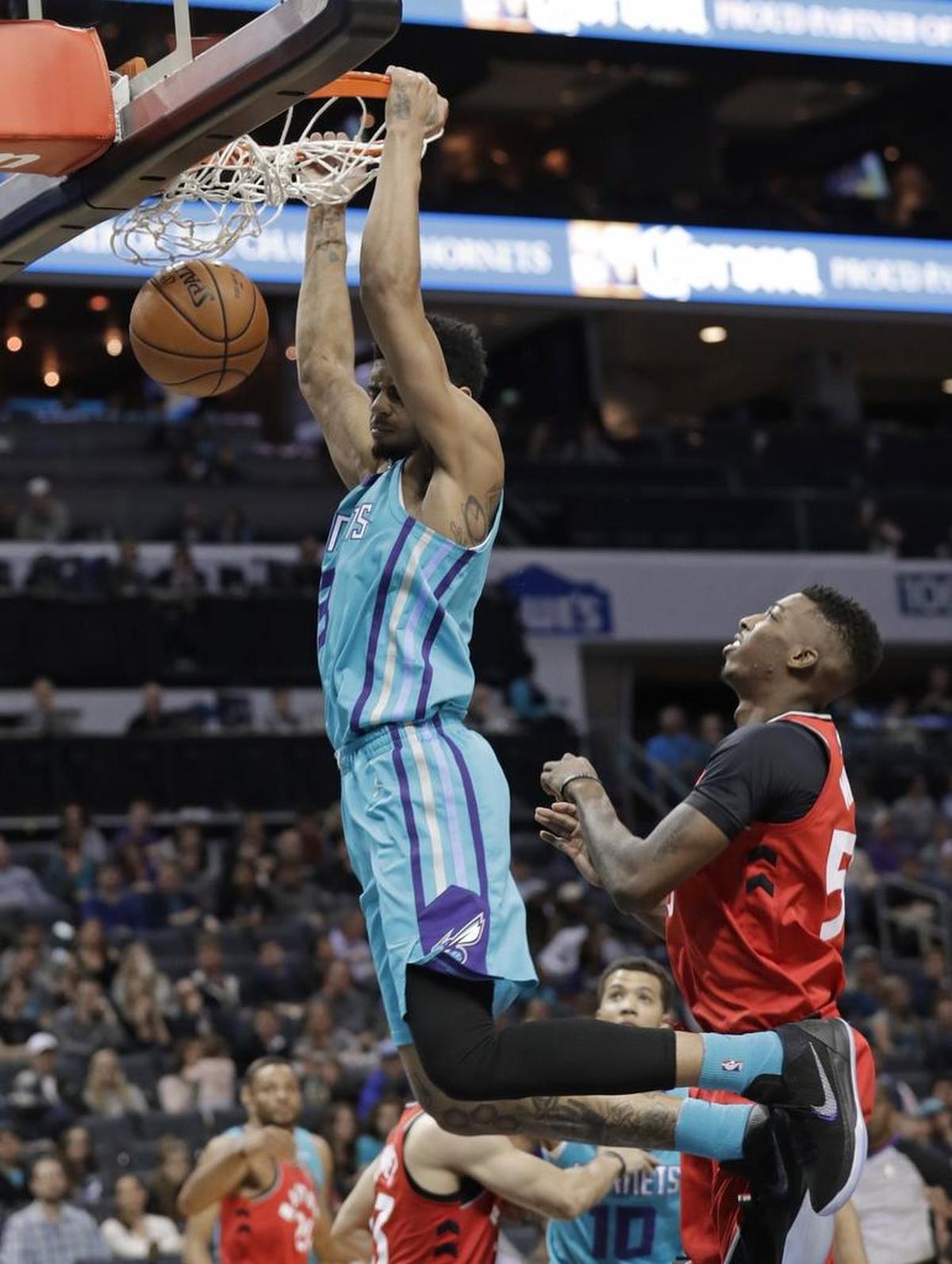 Charlotte Hornets guard Jeremy Lamb (3) dunks past the Toronto Raptors’ Delon Wright (55) for two of his 32 points on Wednesday.