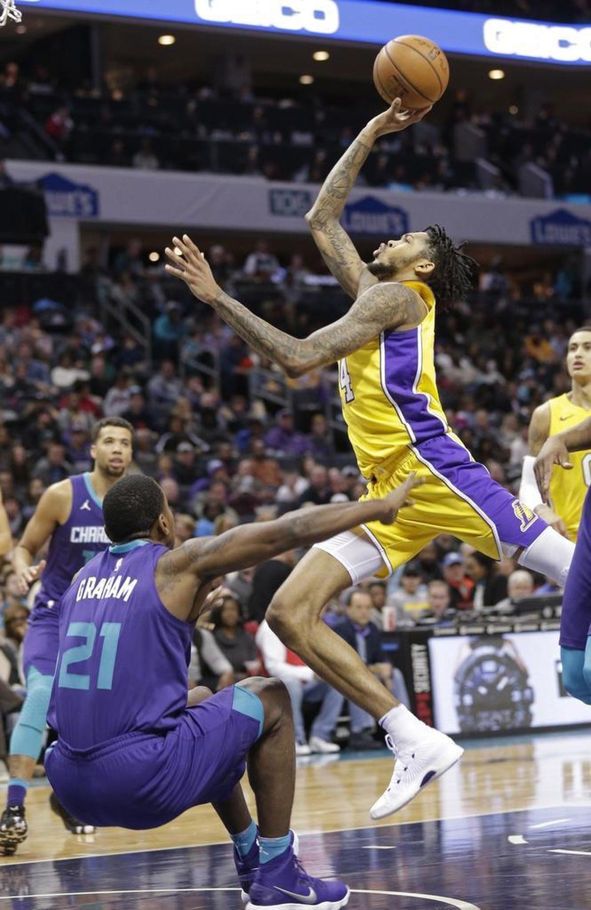 Lakers wing Brandon Ingram, right, used his length to get around Hornets defenders on offense and also to disrupt opposing shots on defense.