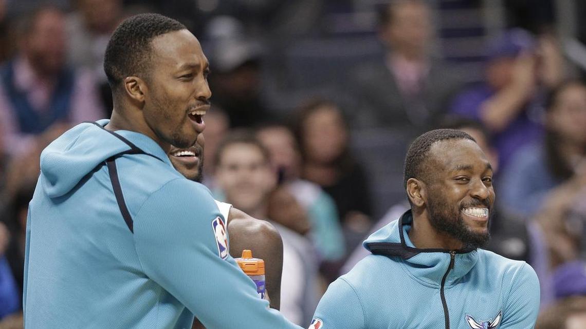 Charlotte Hornets center Dwight Howard, left, and point Kemba Walker celebrate at the end of a 118-102 victory over the Minnesota Timberwolves Monday night.