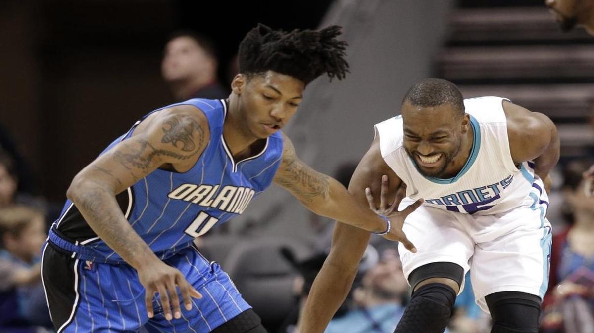Charlotte Hornets guard Kemba Walker, right, and Orlando Magic's Elfrid Payton (4) chase a loose ball during Friday’s game.