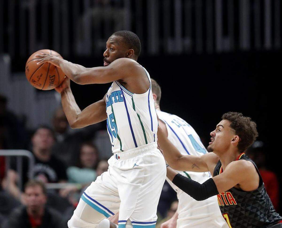 Charlotte Hornets guard Kemba Walker, left, had his fourth consecutive game scoring 30 or more points in Saturday’s road victory over the Atlanta Hawks.