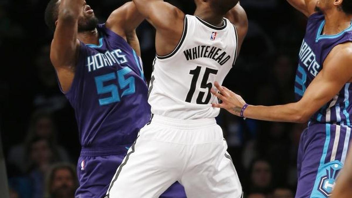 Charlotte center Roy Hibbert (55) and guard Jeremy Lamb (3) collapse on Brooklyn guard Isaiah Whitehead during the first half of Monday night’s game in New York. The Nets won 120-118.