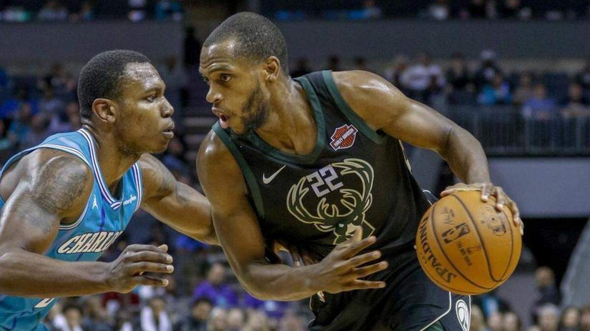 Charlotte Hornets reserve Treveon Graham, left, guards Milwaukee Bucks forward Khris Middleton Saturday at Spectrum Center. Graham came up big in Saturday’s victory.