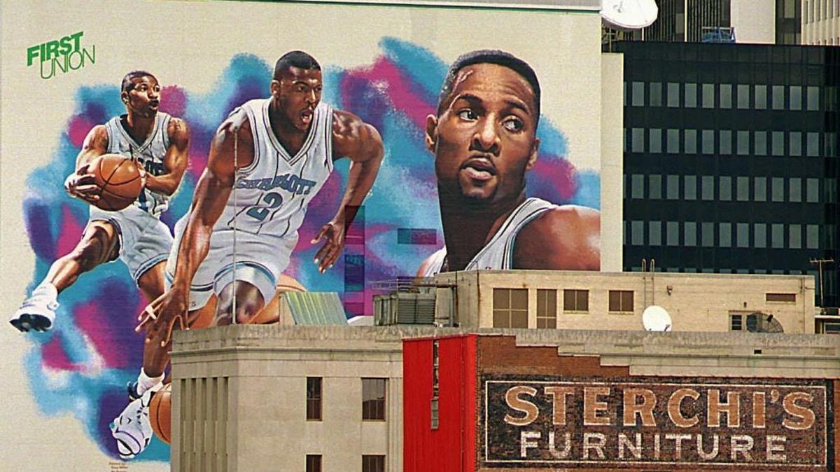 Then-Charlotte Hornets players Muggsy Bogues (left to right), Larry Johnson and Alonzo Mourning showed off the original pinstripe uniforms on a mural uptown in 1994.