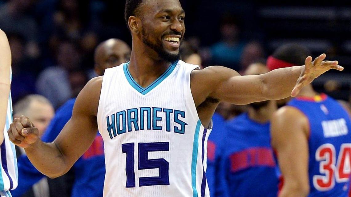 Charlotte Hornets guard Kemba Walker reaches out to congratulate a teammate following a score during first half action vs the Detroit Pistons on Friday, March 11, 2016 at Time Warner Cable Arena in Charlotte, N.C.