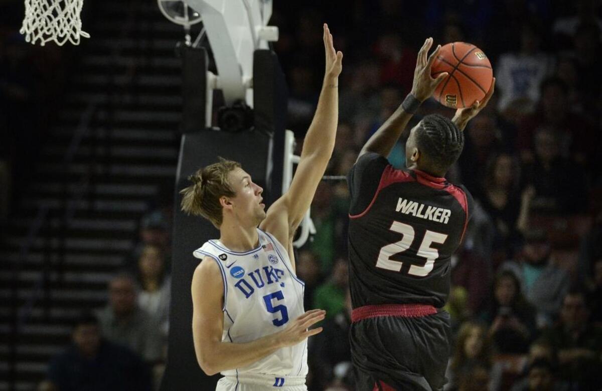 Duke guard Luke Kennard, left, contests a shot by Troy forward DeVon Walker (25) in the 2017 NCAA basketball tournament. “I like to be pushed. I like when coaches are on me, always giving me teaching points. Coach K was that way with me,” Kennard, left, now with the Detroit Pistons, said.
