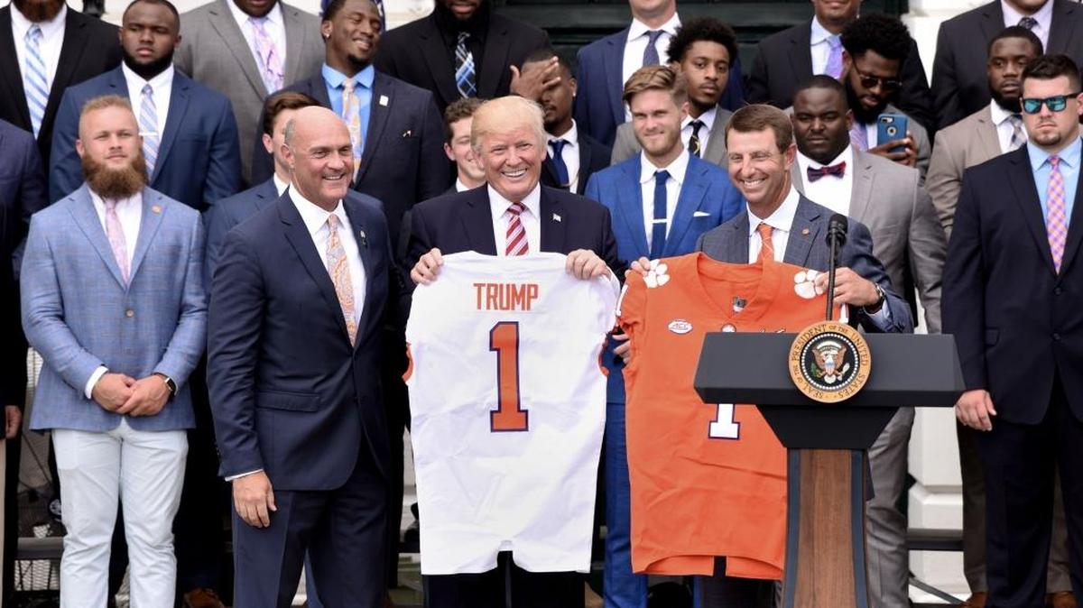 President Donald Trump (center, holding jersey) hosted Clemson’s national championship football team Monday at the White House.